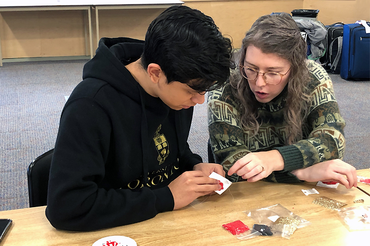 photo: Alexander Gomez Sanchez works with Jenna Lemay, a Shinghauk Residential School Centre digital archives technician (Reid Locklin)