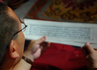 Man reading Nepal manuscript