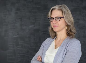 Pamela Klassen in front of chalkboard